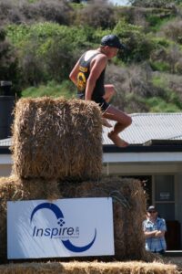 Over the hay bale mountain - three tiers high. Note bare feet - these guys and girls are made of tough stuff